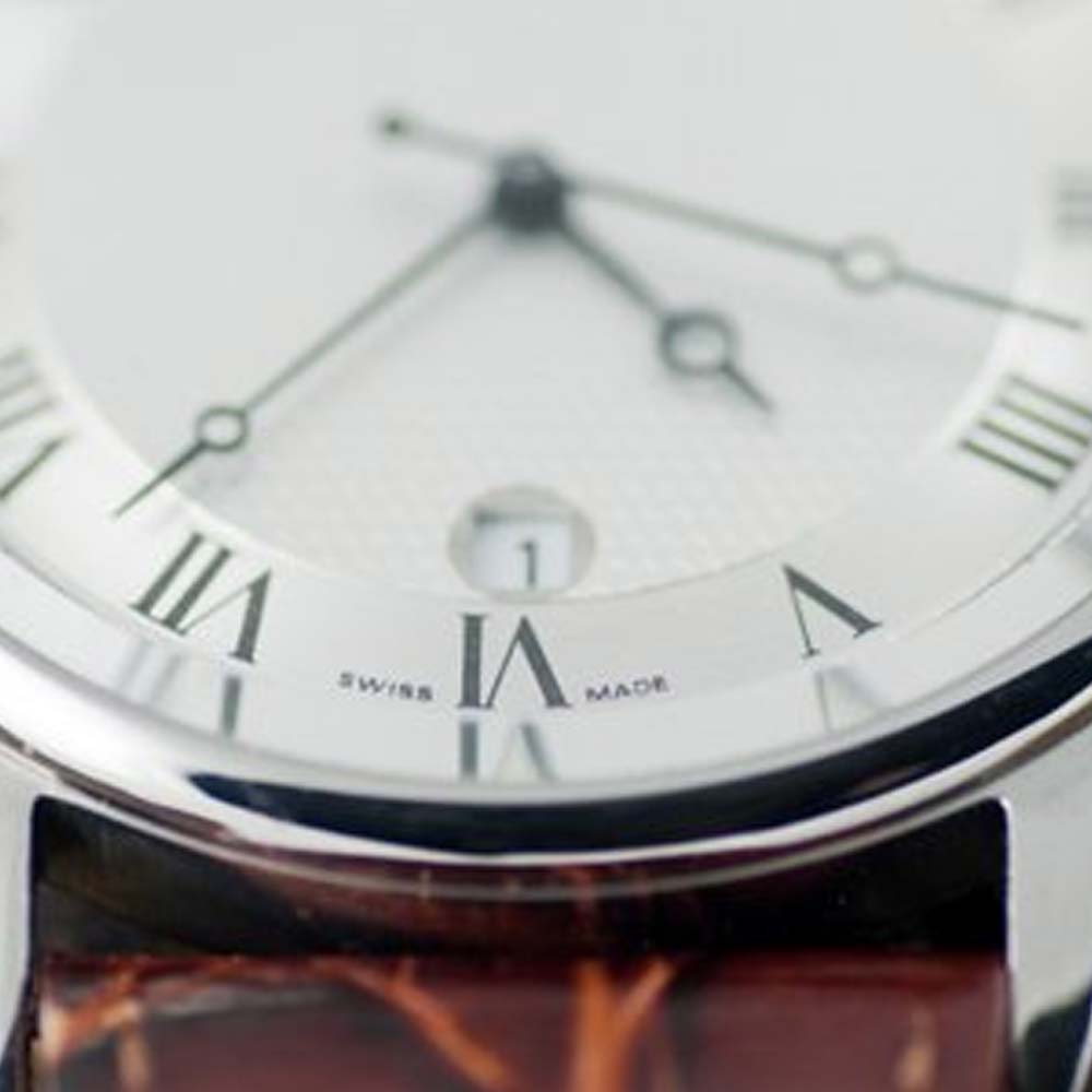 a close up of a watch on a tree stump