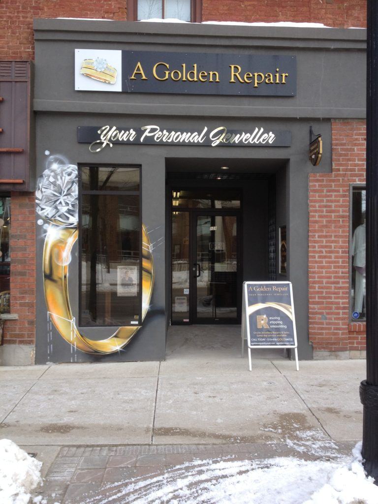 a jewellery store that has a sign in front of it
